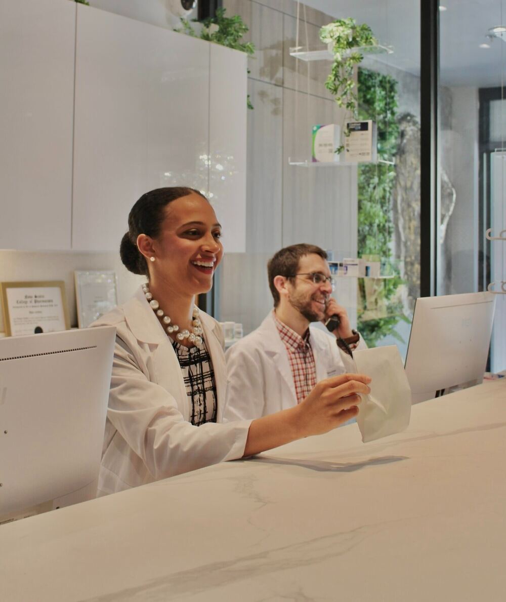 Two Cunard pharmacists at the waterfront clinic counter